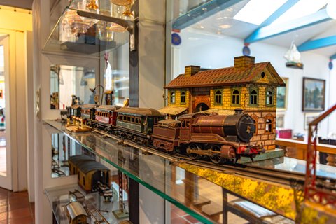 Regal mit Modellbaubahnen und -häusern im Flur von Haus Kreienhoop