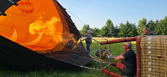 Miroslav dreht den Gashahn am Ballon auf, damit dieser sich durch das Feuer mit heißer Luft füllt