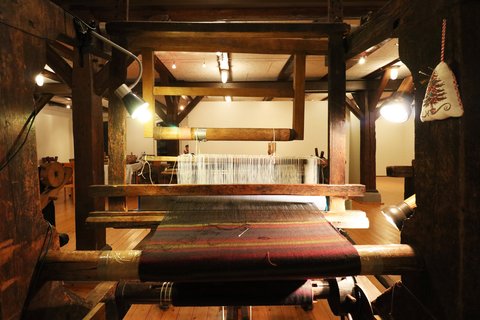 Blick auf den fast fertigen Läufer im Webstuhl